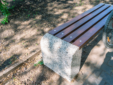 A bench for people to rest in a city park. Bench and rest after cycling.の写真素材