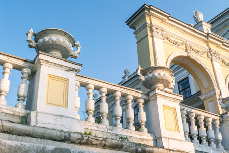 A vase made of stucco on an old building of the 19th century. A flowerpot on the facade of a mansion built in the 19th century. Ancient architecture with stucco on the facade.の写真素材