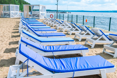 Wooden chaise longue for relaxing on the beach with a soft removable mattress. Relaxing on the beach...