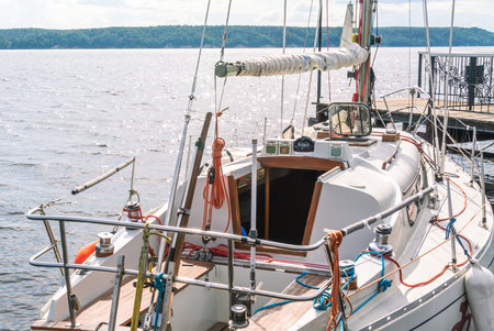 A white yacht is launching. River sailing yacht with a cabin. Deck on the yacht. Summer vacation on the water expansions.の写真素材