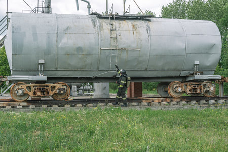 A rescuer next to a tank car when a chemical product leaks during the liquidation of an accident....