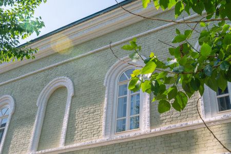 An old renovated brick building built in the 19th century. Renovated facade of an old house. The yellow color of the paint used to paint the facade of the building. Renovated houseの写真素材