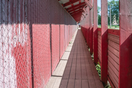 A canopy to protect people during construction work. Protection against falling structures and materials during the construction of buildings on the street. Sawn boards for construction work.の写真素材