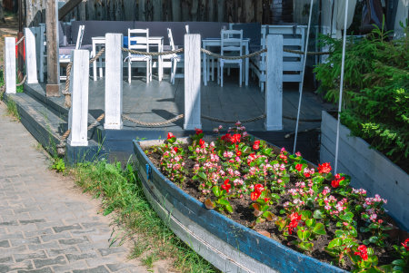 White wood furniture in the kitchen. Wooden furniture on the terrace of the house in summer. Rest in the village. Chairs and tables made of natural wood. Gazebo for sun protection with furniture.の写真素材
