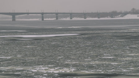Frozen water surface on the river in winter. Ice on the river. Frozen water. The solid state of water at subzero temperatures in winter. Winter landscape on a frozen river. Riverbank in winterの写真素材