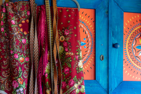 The interior in the kitchen of an old country house. An old cupboard with drawings and patterned...