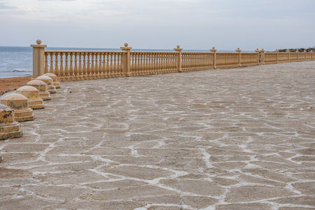 Construction of an embankment by the sea. Landscaping of the coastal area. Buildings near the shore....