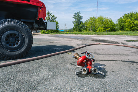 A fire barrel with high water consumption for extinguishing large fires. The fire barrel is next to the fire truck. Fire fighting equipment for extinguishing a fire at a great distance.の写真素材