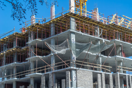 Reinforced concrete bearing supports of the frame of a high - rise building under construction....