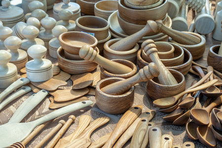 Wooden cutlery. Wooden kitchen utensils are displayed in the background. Wooden mortars and spoons....