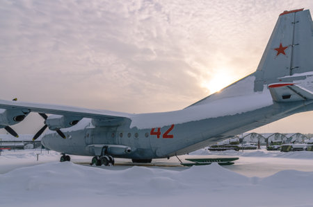 A screw military transport aircraft. A military cargo plane at the airfield in winter. Military...