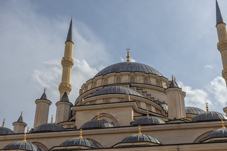 The mosque is made in the classic Ottoman style. View of the grand Mosque. A mosque with minarets and a blue sky with clouds. A place for prayers.の写真素材