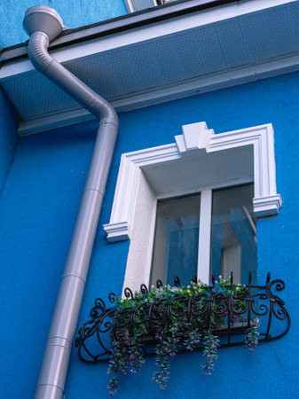 Drainpipe outside the building. A drainage system is designed to drain meltwater and rainwater. Drainage system to protect the building from the negative effects of atmospheric precipitation.の写真素材