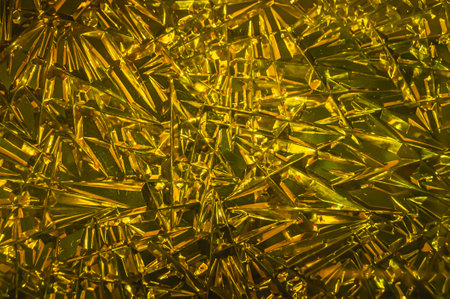 Glass background with a golden hue. The surface of the glass with refractive sunlight.
