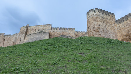 The walls of the ancient fortress are made of large stone blocks. View of the ancient Persian citadel. Ancient defensive structures. The high walls of the fortress in the Caucasus.の写真素材