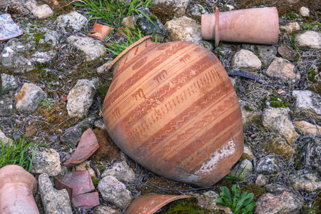 An amphora and fragments of ancient jars made of clay. The interior on the street in the ancient...