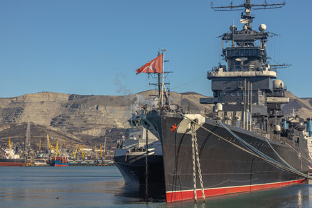 The museum ship is moored at the eternal parking lot in the port of Novorossiysk. A Soviet cruiser in the port. A warship with cannons. A large warship at the pier.の写真素材