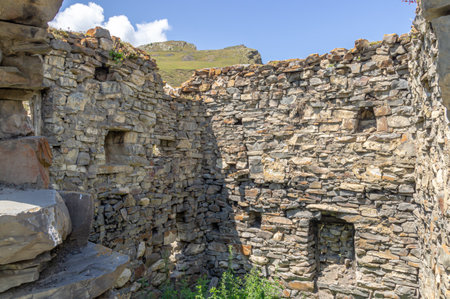 A dilapidated medieval architectural complex located high in the mountains. The largest mountain settlement in North Ossetia. The Great Silk Road passed through the gorge where the Galiat is located.の写真素材