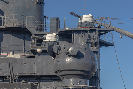 The deck of a battlecruiser with guns. A Soviet cruiser in the port. A warship with guns. Naval armament. The barrels of the cruiser's guns. The gun turret of a warship.の写真素材