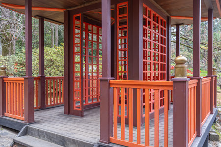 Japanese garden with wooden buildings. Japanese-style landscape design. A park with exotic trees. An oriental-style park area. Japanese-style gazebo.の写真素材