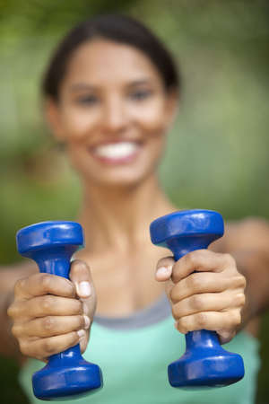 Young woman exercising in outdoor setting. Vertically framed shot.の写真素材