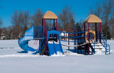 Park with playground equipment in the winterの写真素材