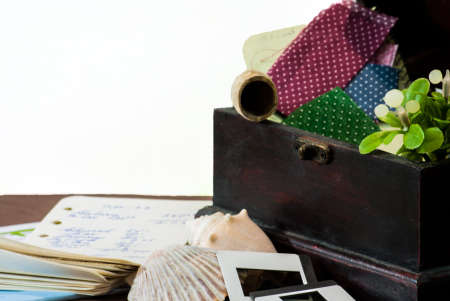 Memory Box with quilt samples, a clay pipe, sea shells, slides