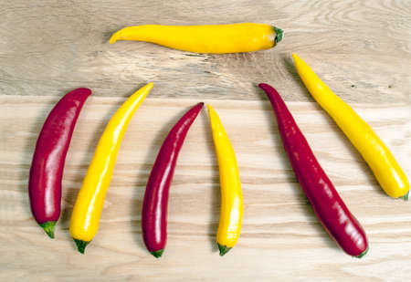 Red and Yellow Hot Peppers on Wooden Board