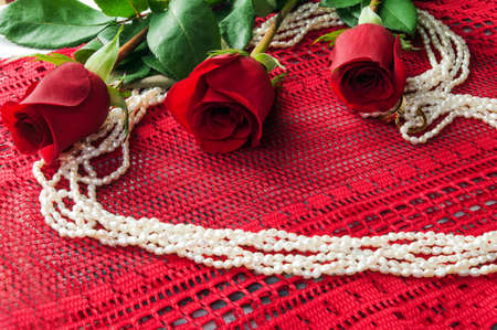 Three Roses on diagonal and Pearls in the shape of a heartの写真素材