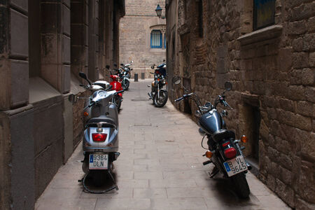 Barcelona,Spain - October 5.2007:Narrow old street with parked motorcyclesのeditorial素材