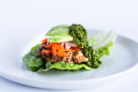 Tuna tartare with avocado sauce on white plate