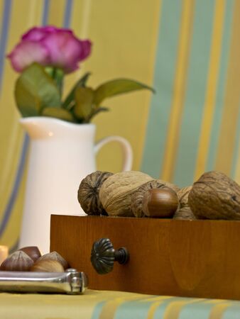 Walnuts, hazelnuts and peanuts in a drawer with a Nutcrackerの写真素材