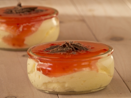 Vanilla pudding with strawberry sauce, topped with chocolate chipsの写真素材