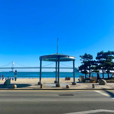 A high angle shot of a gazebo on the beach under a blue skyの写真素材