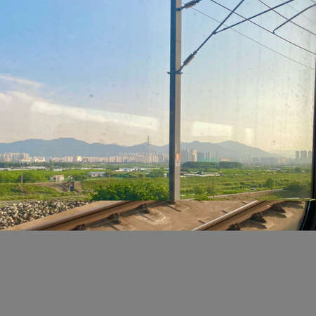 View from the window of a train with a view of the cityの写真素材
