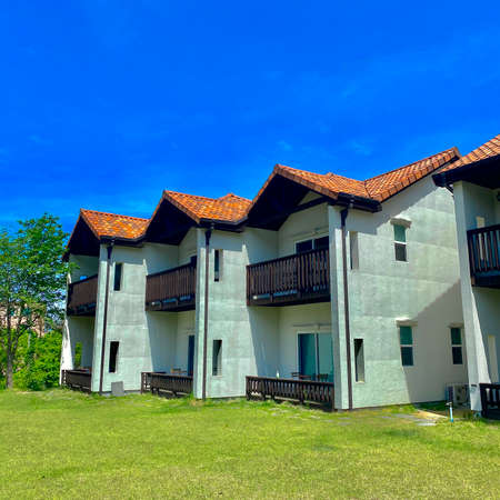 Facade of a modern house with terracotta tile roofs.の写真素材