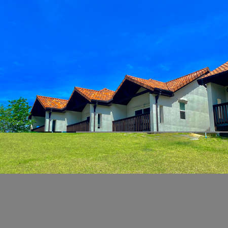 House in the countryside with a blue sky in the background. High quality photoの写真素材