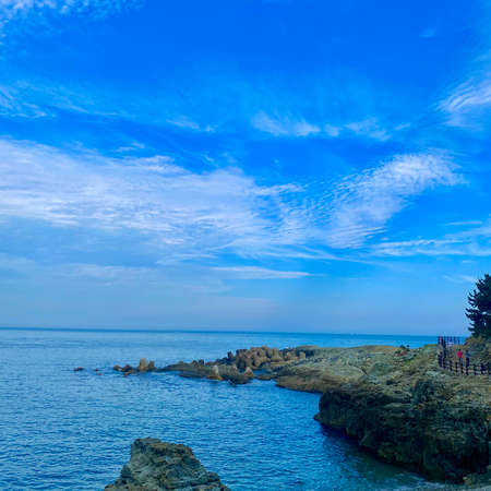 Rocky coast of the Black Sea against the blue sky with cloudsの写真素材