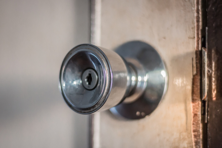Old metal door knob On white wooden doorsの写真素材