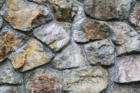 stacked up rust colored rock wall face