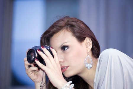  latin woman in her early twenties with camera.  She is from Bolivia and was photographed July, 2009 in the USA. の写真素材