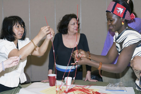 Several Christian believers participate in a game held during the Trinity Baptist Church fellowship dinner.  Shown here the members compete  against another table of Christians on who can build the highest tower within a specific amount of time.  The churのeditorial素材