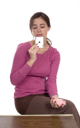 A Caucasian woman sits and plays cards while thinking.の写真素材