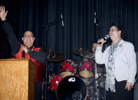 Bronx, NY - April 9: Pentecostal Christian singers Hector Delgado and Carmen Sanabria sing during Christian concert held at Lehman High School. Taken April 9th, 2011 in the County of the Bronx, NY.のeditorial素材