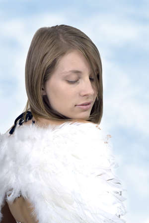Young girl wearing angel wings.  Photographed in studio. の写真素材