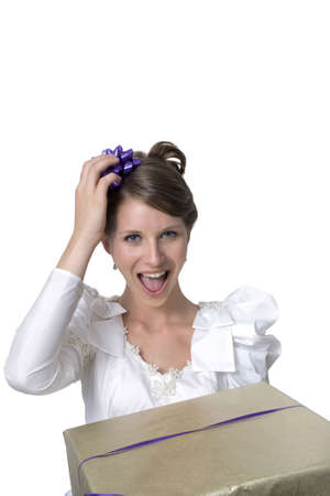 Young girl wears wedding dress and holds gift.  Photographed in studio.  の写真素材