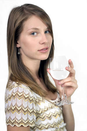 Studio image of girl holding wine glass.  She was 19 at the time of shoot and is of Irish ethnicity.  の写真素材