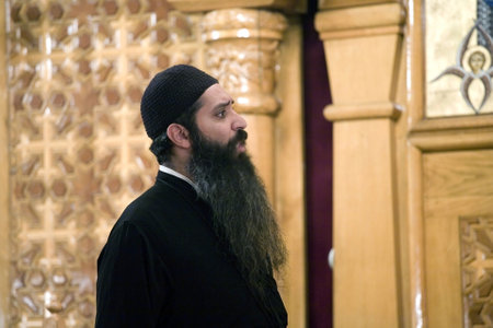 A Coptic Orthodox Priest prays during the Saturday Vespers prayer service inside the Coptic Orthodox Church of St George in Brooklyn NY, September 2009 in the USA.  のeditorial素材