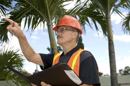 Man directs wearing a construction outfit.  He is a senior and his ethnicity is Puerto Rican.  Photographed in Bayamon, Puerto Rico.の写真素材