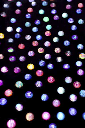 photo of colored plastic balls against a black backgroundの写真素材